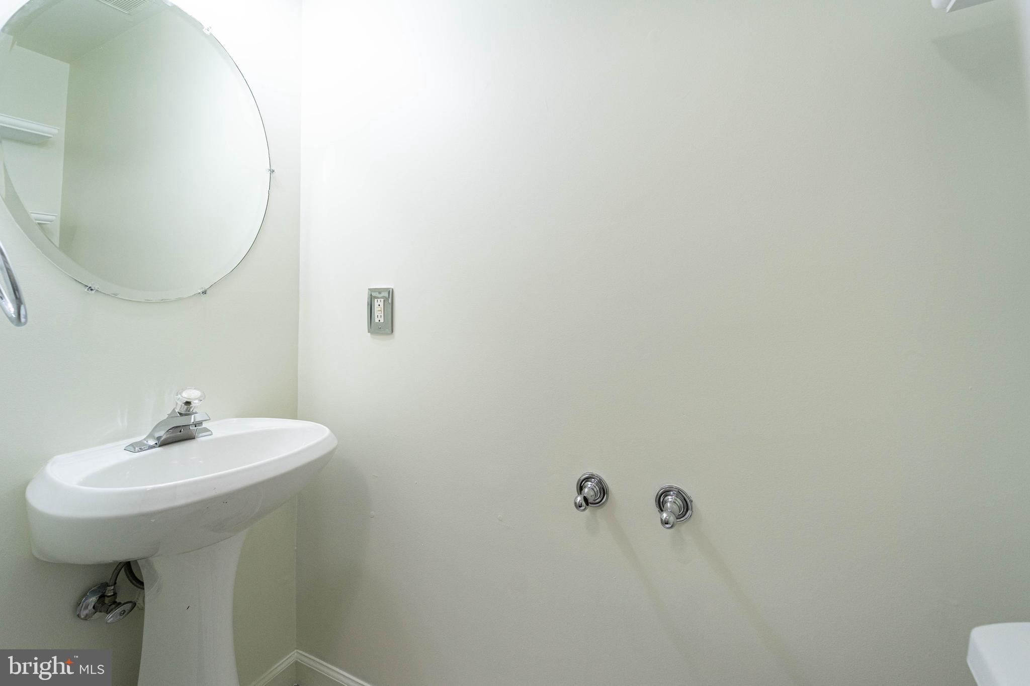 4309 Windflower Way Bowie, MD 20720 - Photo 21 of 46 a bathroom with a sink a toilet and a mirror