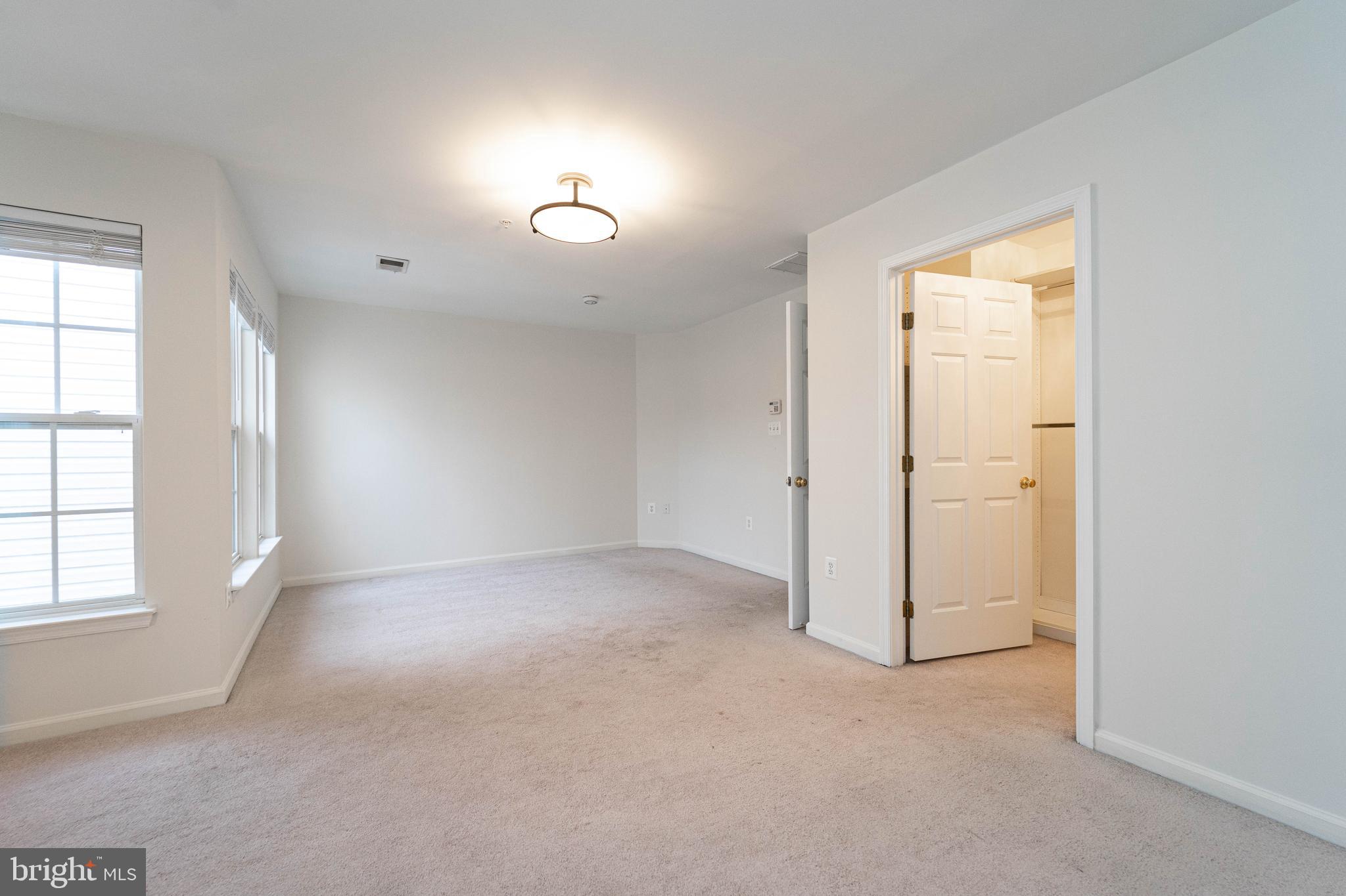 4309 Windflower Way Bowie, MD 20720 - Photo 24 of 46 an empty room with windows and closet