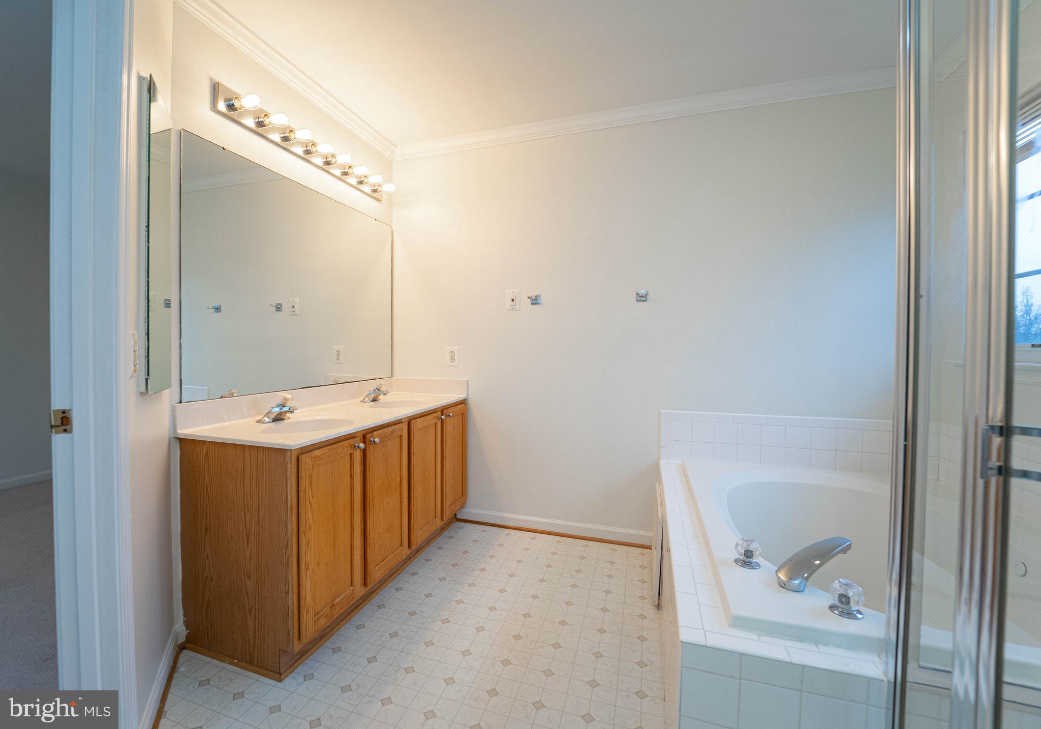 4309 Windflower Way Bowie, MD 20720 - Photo 29 of 46 a bathroom with a double vanity sink and mirror