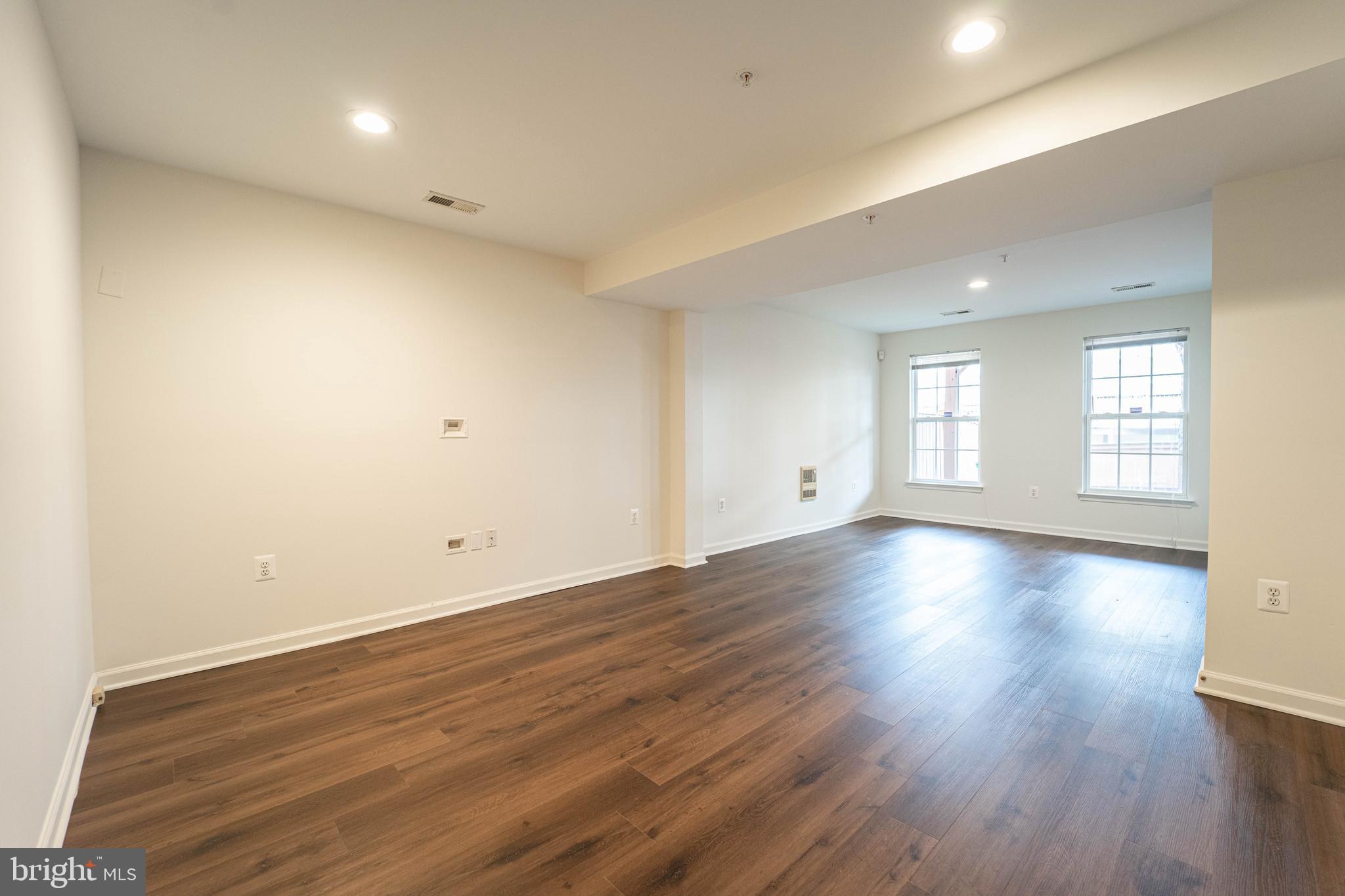 4309 Windflower Way Bowie, MD 20720 - Photo 3 of 46 an empty room with wooden floor and windows