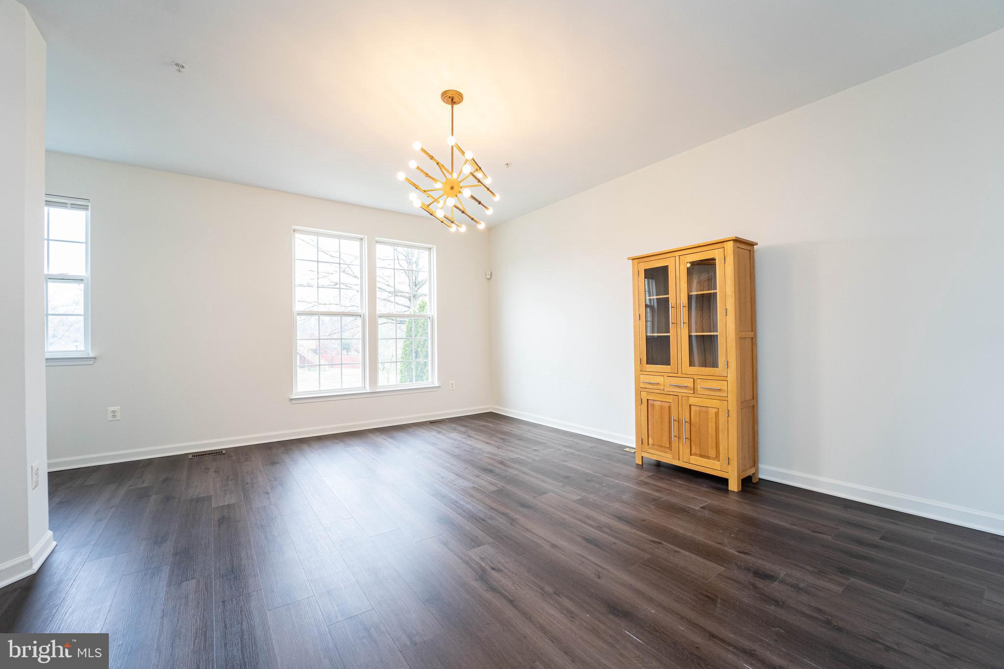 4309 Windflower Way Bowie, MD 20720 - Photo 46 of 46 a view of an empty room with wooden floor and a window