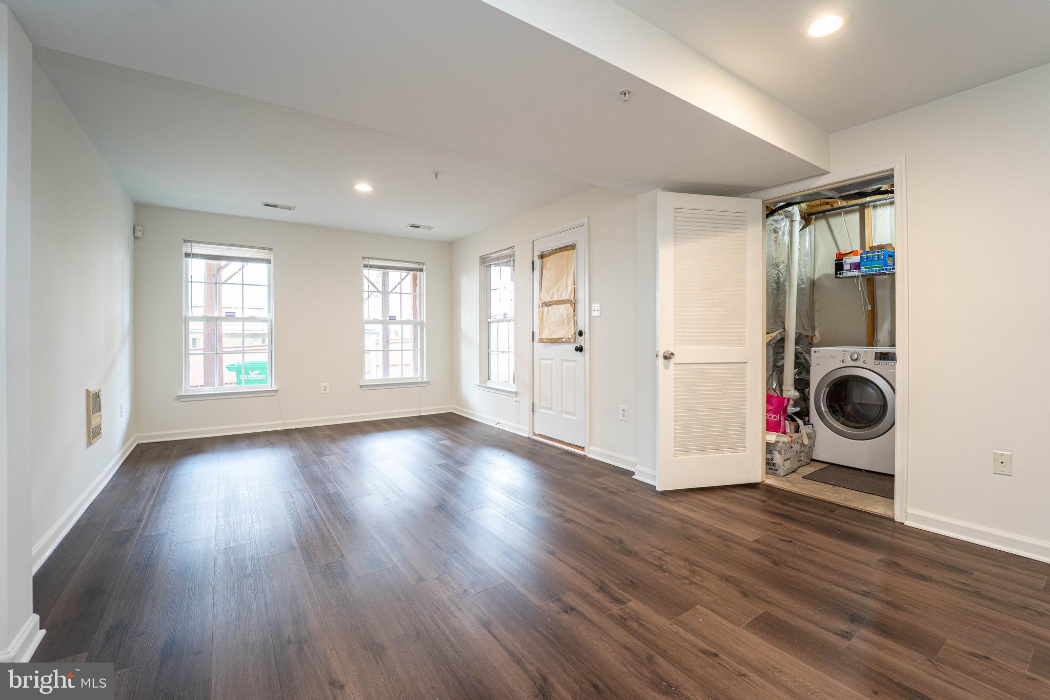 4309 Windflower Way Bowie, MD 20720 - Photo 5 of 46 a view of an empty room with wooden floor and a window