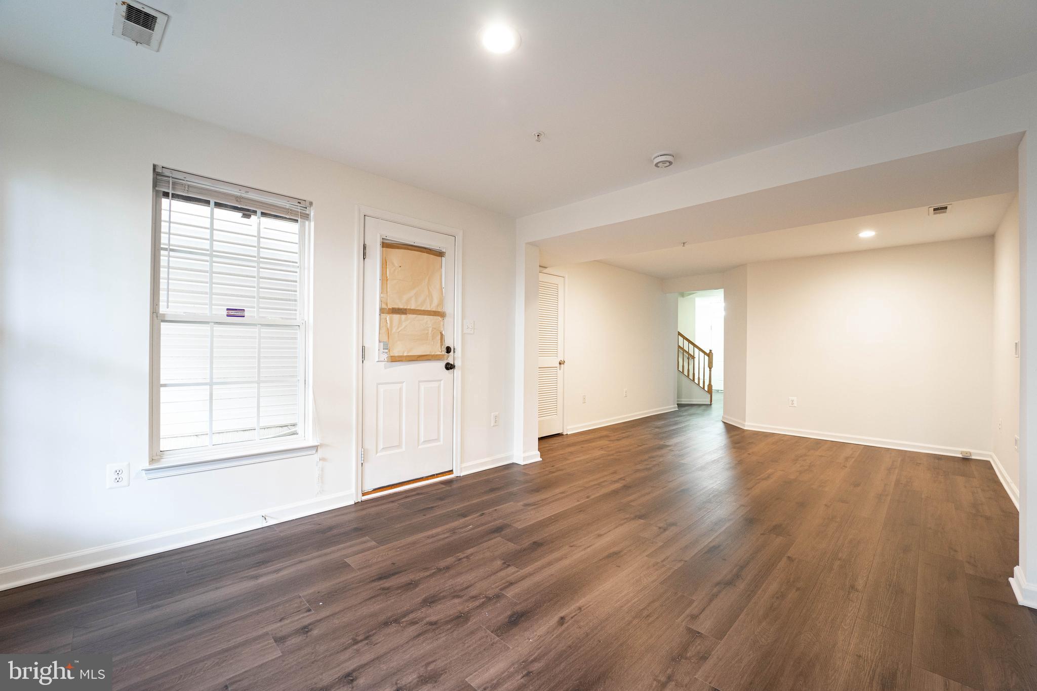 4309 Windflower Way Bowie, MD 20720 - Photo 7 of 46 an empty room with wooden floor and windows
