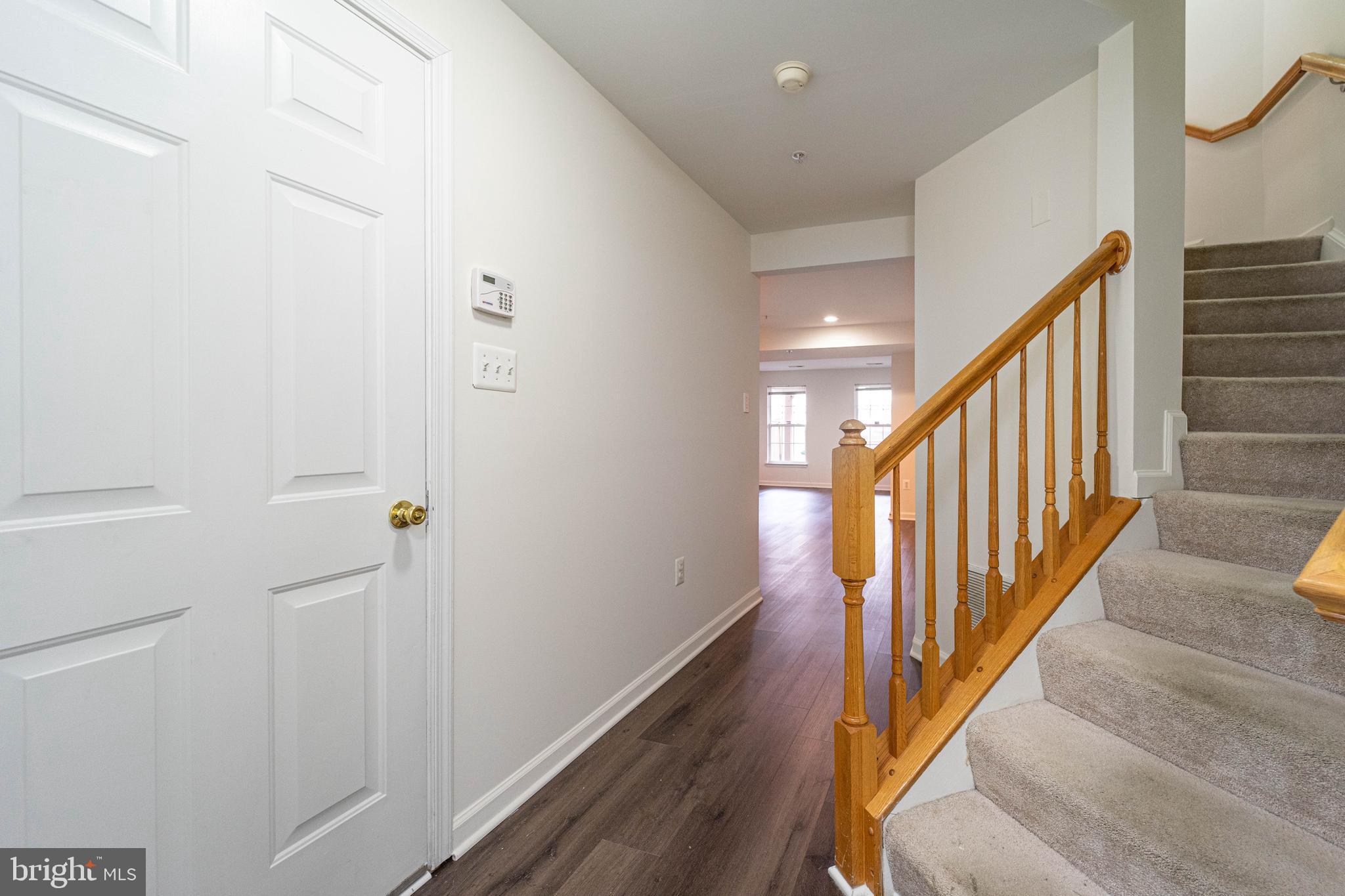4309 Windflower Way Bowie, MD 20720 - Photo 8 of 46 a view of a hallway with wooden floor and staircase
