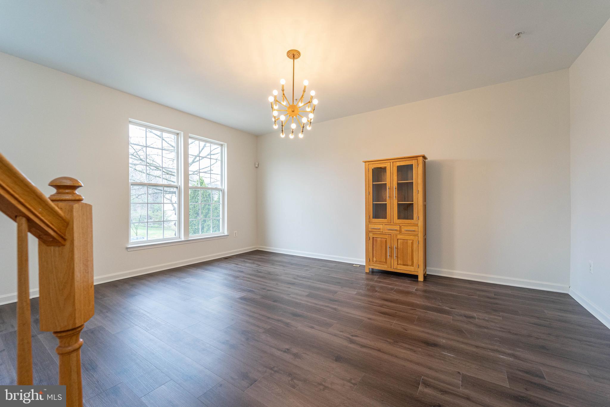 4309 Windflower Way Bowie, MD 20720 - Photo 9 of 46 a view of an empty room with wooden floor and a window