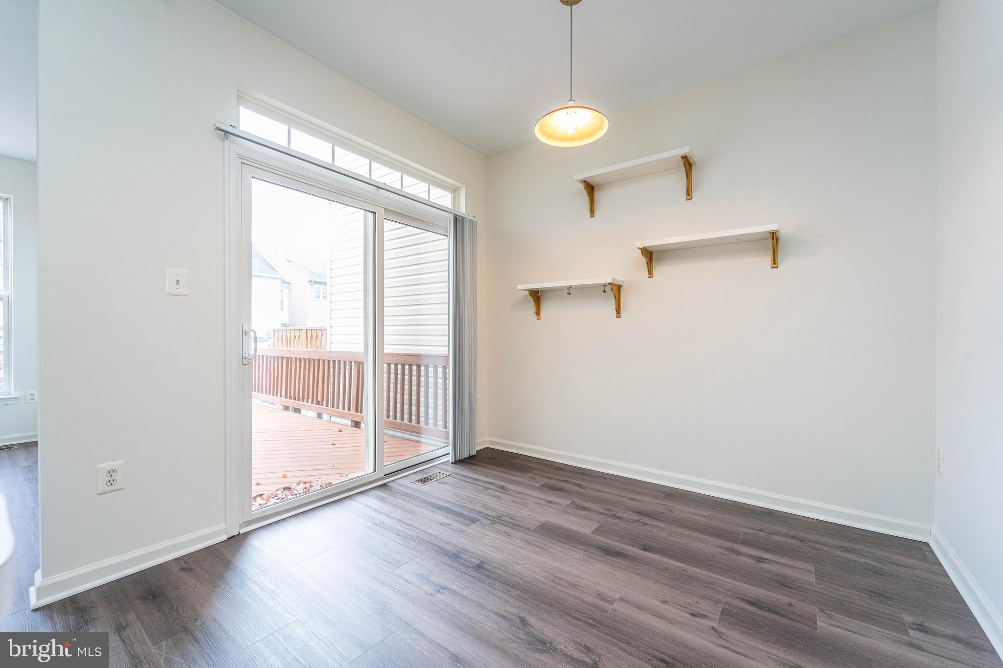 4309 Windflower Way Bowie, MD 20720 - Photo 10 of 46 a view of an empty room with wooden floor and a window