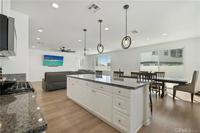 a large kitchen with stainless steel appliances granite countertop a stove a sink and a granite counter tops