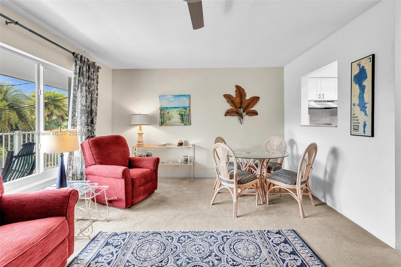 a living room with furniture a rug and a large window