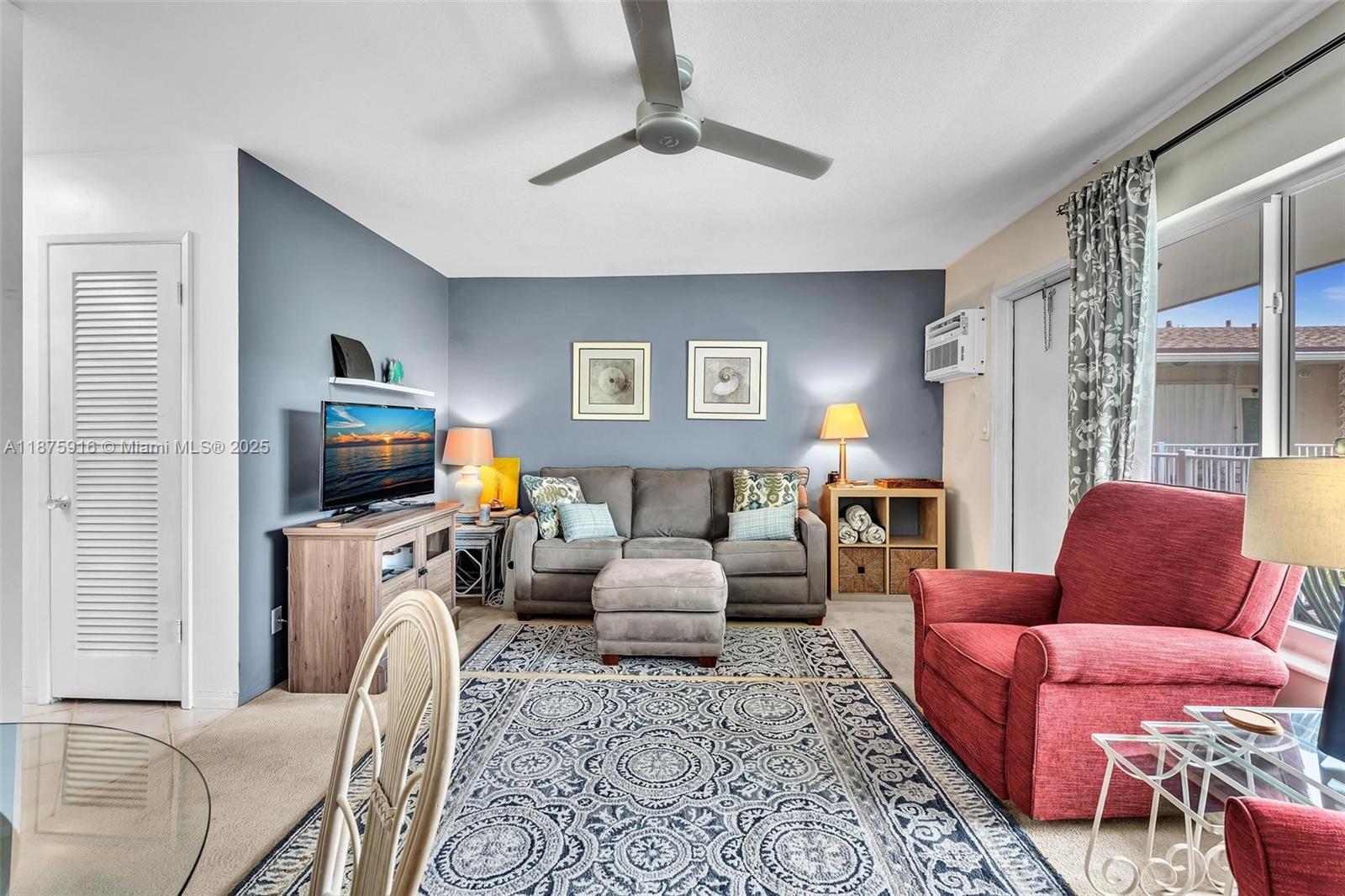 2501 North Ocean Boulevard, Unit 18 Pompano Beach, FL 33062 - Photo 13 of 36 a living room with furniture a flat screen tv and a fireplace