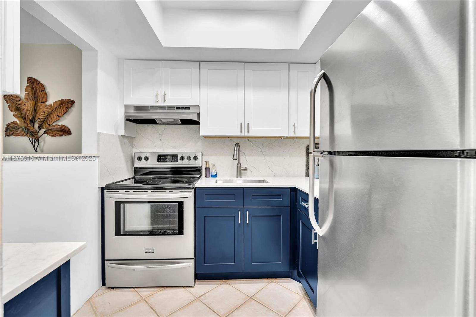 2501 North Ocean Boulevard, Unit 18 Pompano Beach, FL 33062 - Photo 17 of 36 a kitchen with stainless steel appliances a stove a refrigerator and cabinets