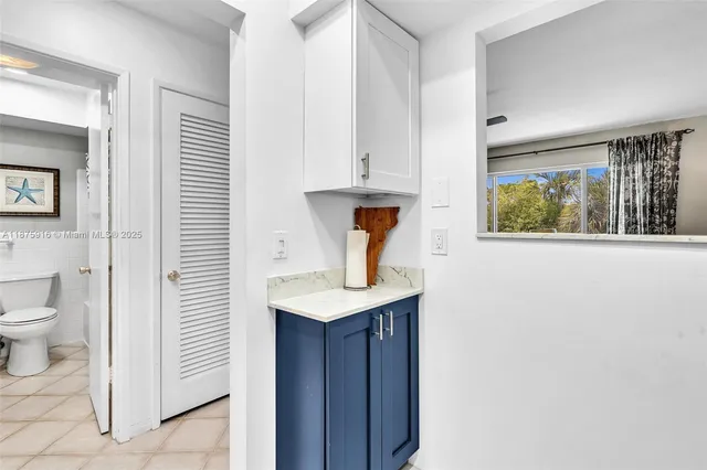 a bathroom with a sink a toilet and vanity