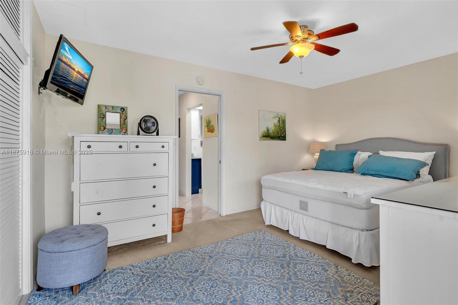 2501 North Ocean Boulevard, Unit 18 Pompano Beach, FL 33062 - Photo 23 of 36 a bedroom with a bed and a television