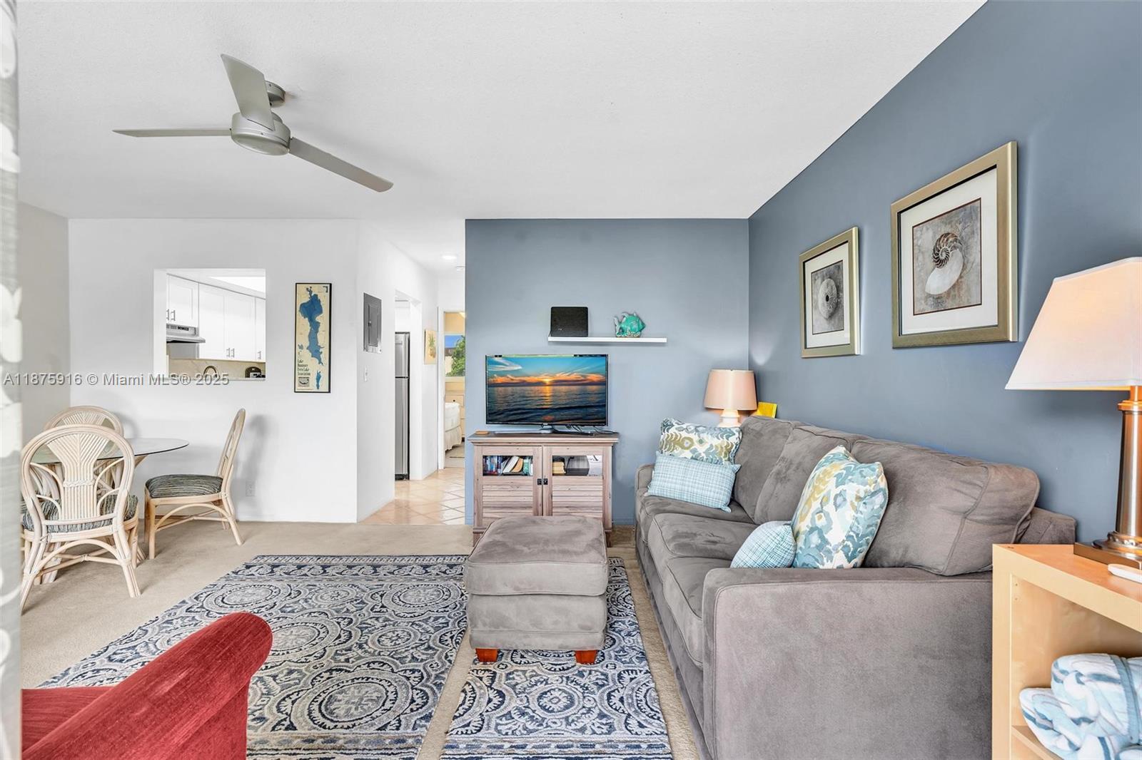 2501 North Ocean Boulevard, Unit 18 Pompano Beach, FL 33062 - Photo 4 of 36 a living room with furniture and a flat screen tv