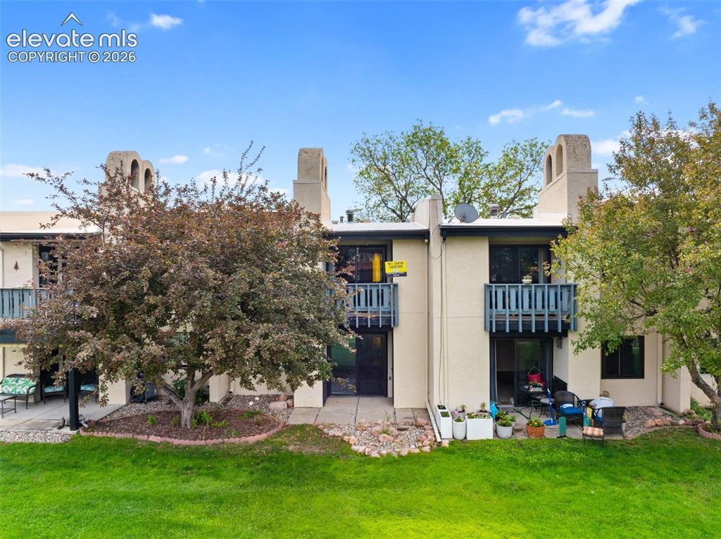 1018 Fontmore Road, Unit A Colorado Springs, CO 80904 - Photo 25 of 28 a view of a house with a yard and sitting area