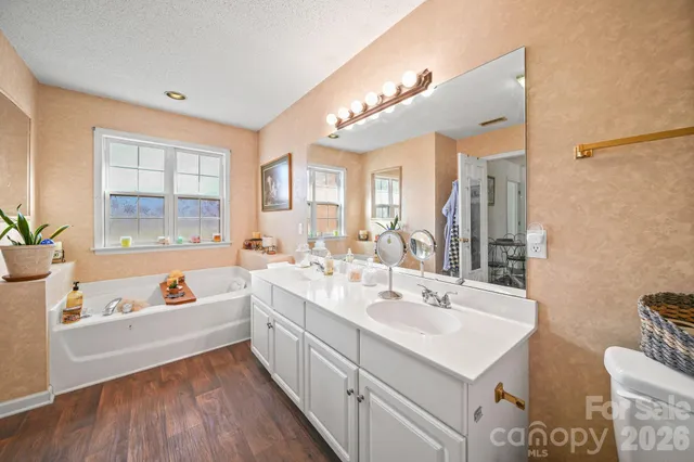 a front view of house with yard and trees in the background