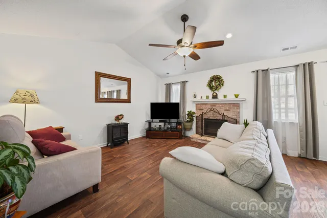 a dining room with furniture a chandelier and wooden floor