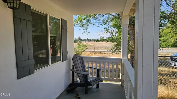a view of a chairs and table in a balcony
