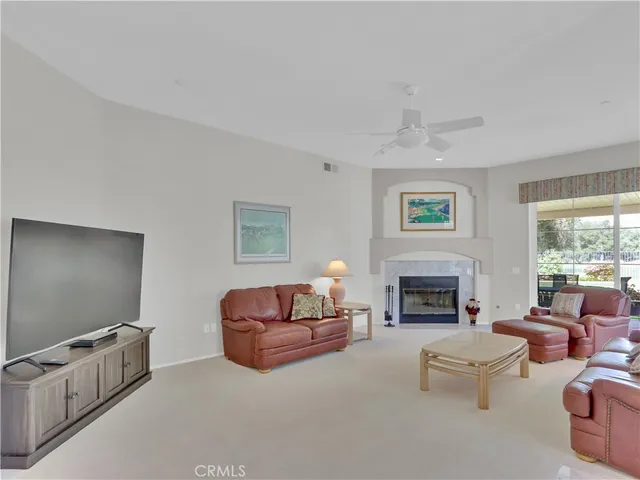 a living room with furniture flat screen tv and a fireplace