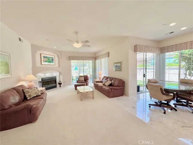 a living room with furniture and large windows