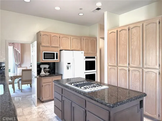 a kitchen with a stove a refrigerator and a sink