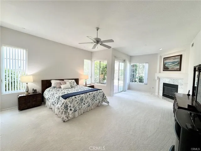 a spacious bedroom with a large bed and a chandelier