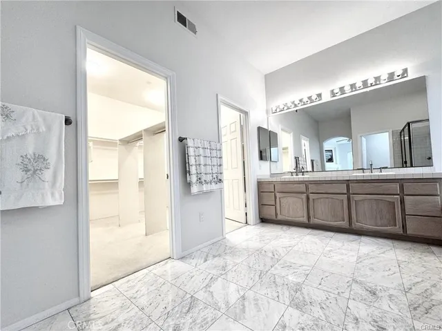 a large bathroom with a large tub sink shower and mirror