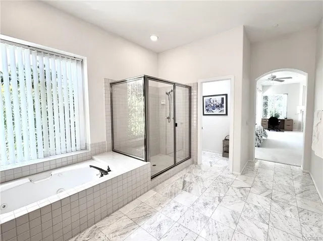 a view of a bathroom with a tub shower and a sink