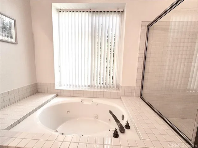 a bathroom with a bathtub and shower