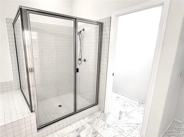 a bathroom with a glass shower door