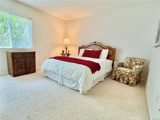 a spacious bedroom with a bed and a couch