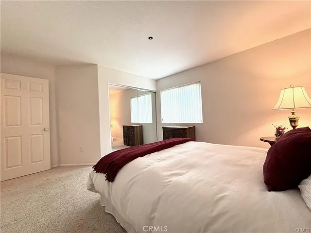 a bedroom with a bed and a lamp