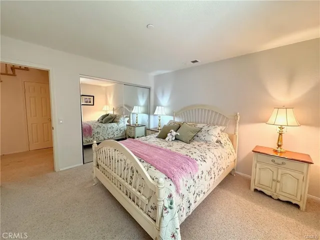 a bedroom with a bed and a lamp