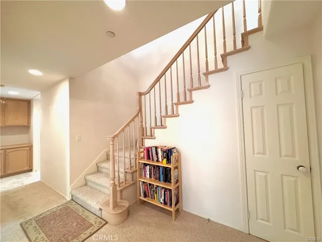 a view of staircase with white walls and windows