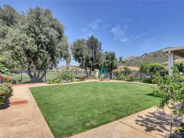 a view of a garden with a building in the background