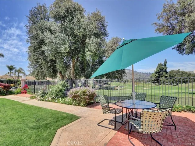 a view of a chair and table in the garden