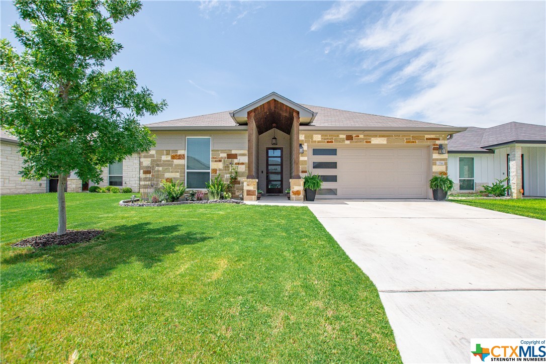 a front view of a house with a yard and garage