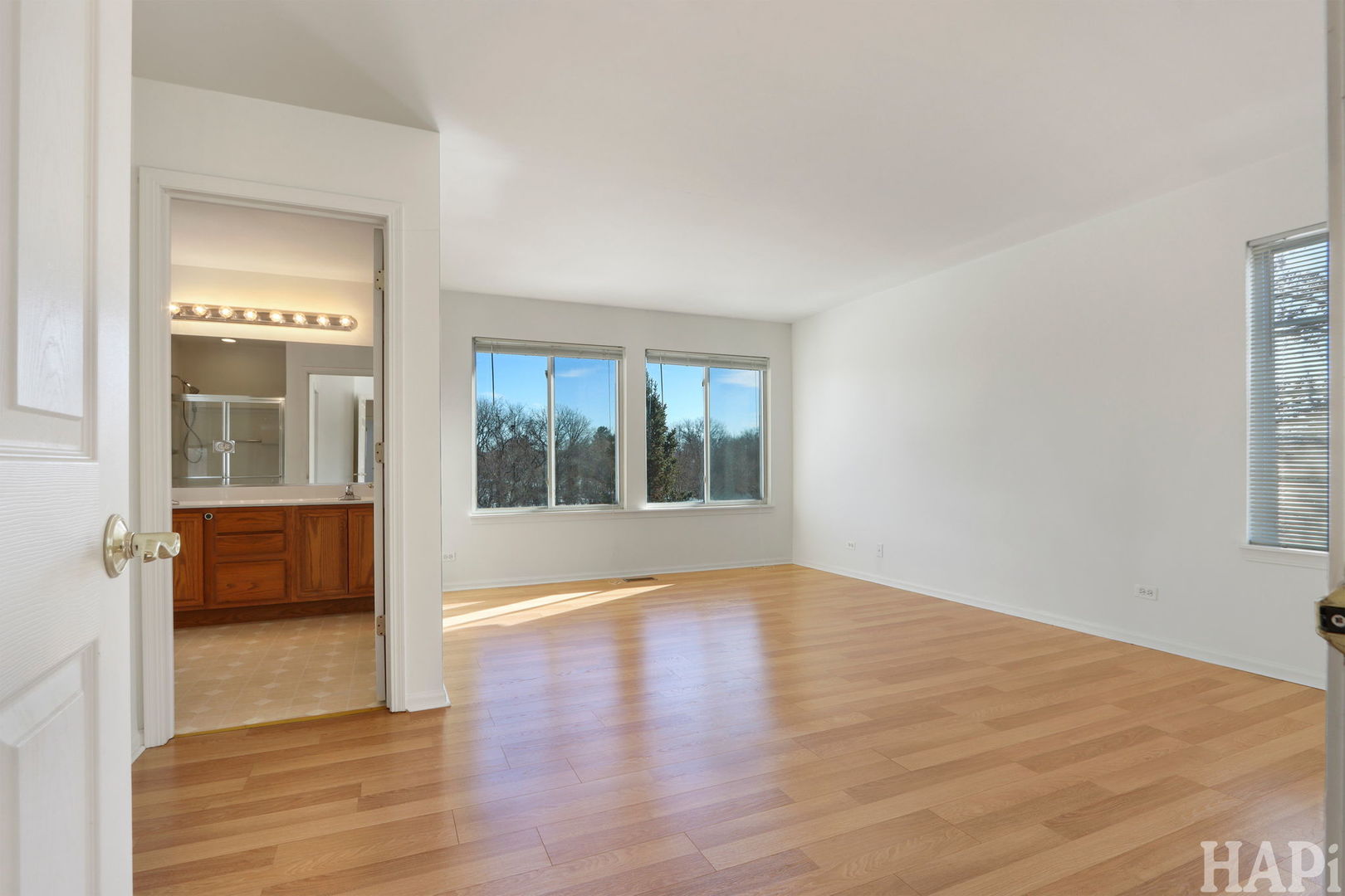 373 Keswick Court, Unit 373 Round Lake, IL 60073 - Photo 12 of 30 a view of an empty room with wooden floor and a window