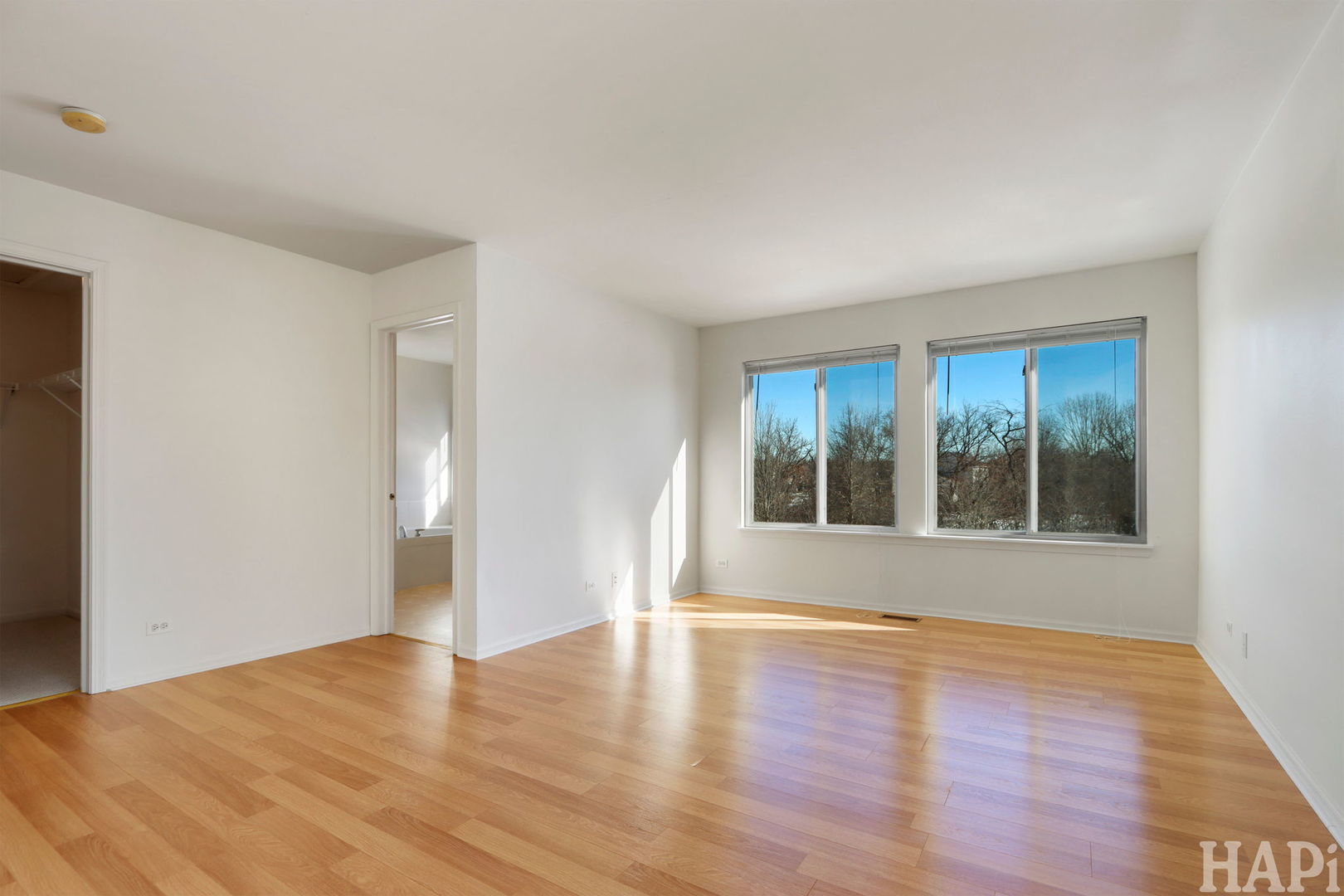 373 Keswick Court, Unit 373 Round Lake, IL 60073 - Photo 13 of 30 a view of wooden floor and windows in a room