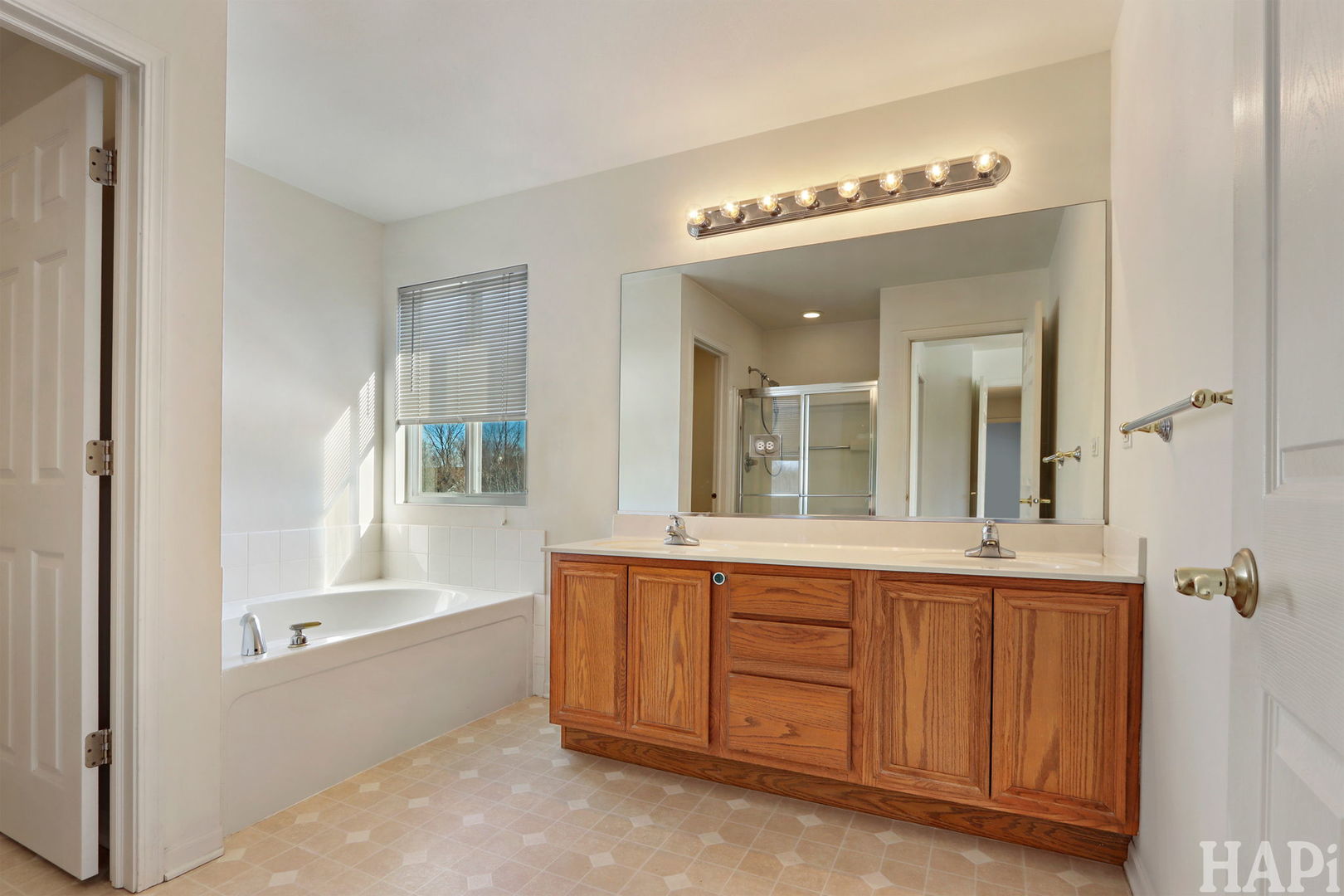 373 Keswick Court, Unit 373 Round Lake, IL 60073 - Photo 14 of 30 a spacious bathroom with a mirror a sink and bathtub