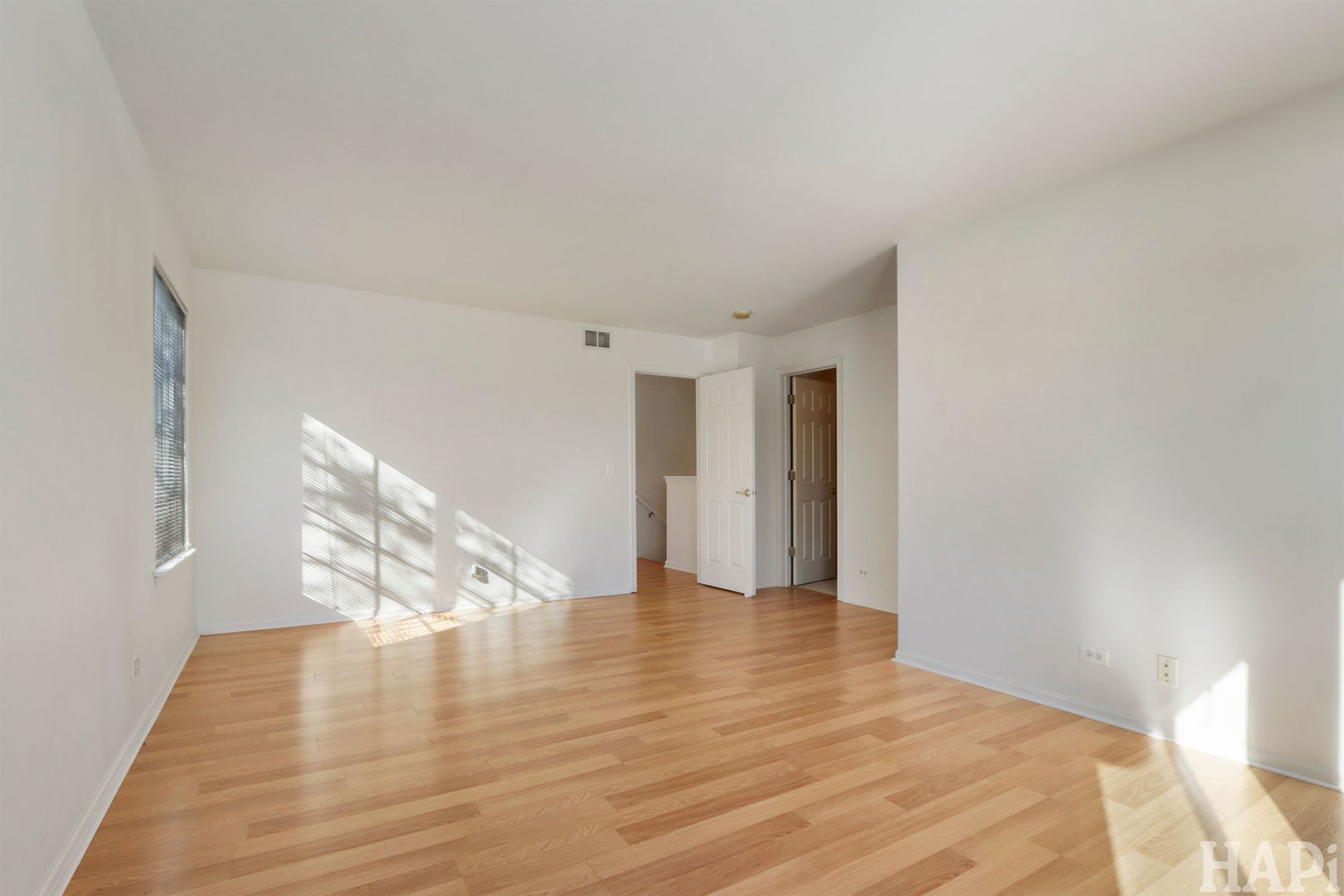 373 Keswick Court, Unit 373 Round Lake, IL 60073 - Photo 16 of 30 a view of an empty room with wooden floor and stairs
