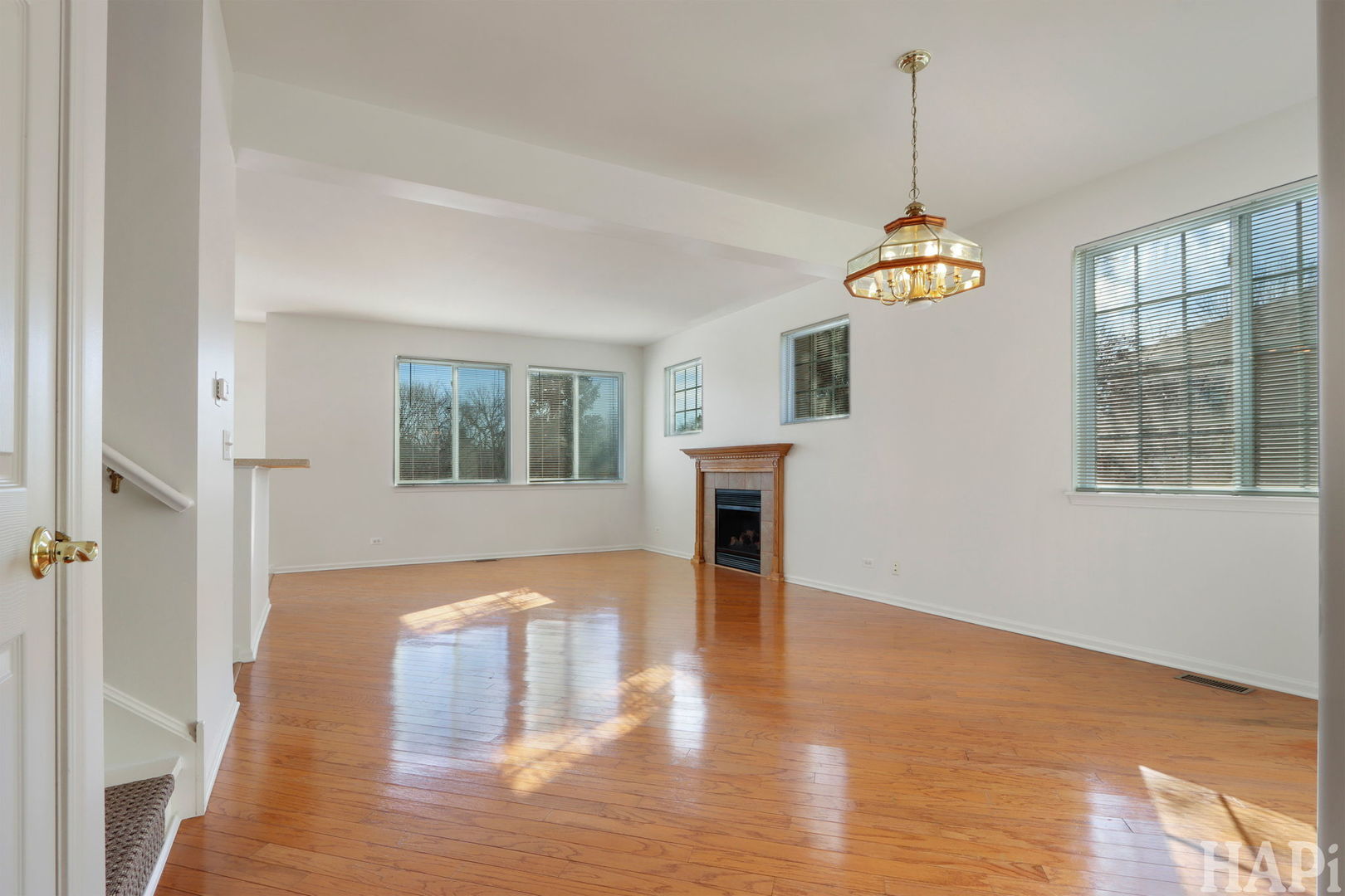 373 Keswick Court, Unit 373 Round Lake, IL 60073 - Photo 3 of 30 a view of empty room with wooden floor and fireplace