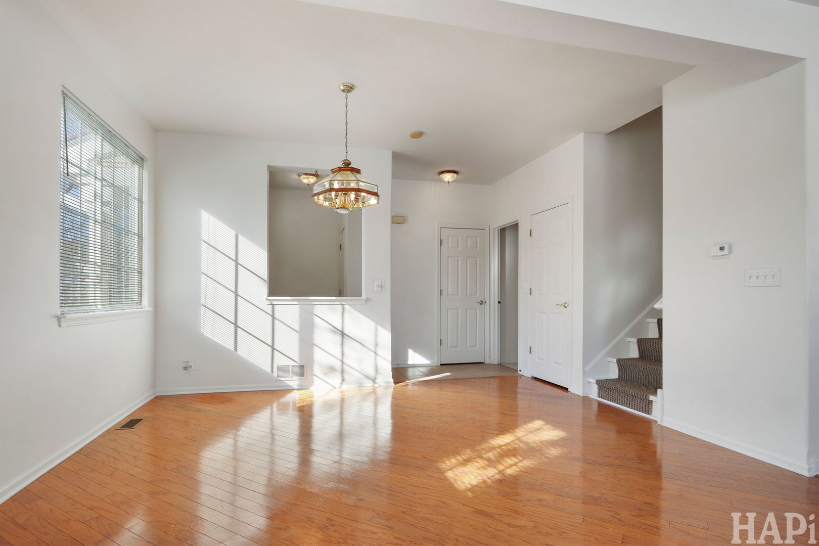 373 Keswick Court, Unit 373 Round Lake, IL 60073 - Photo 5 of 30 a view of an empty room with window and wooden floor