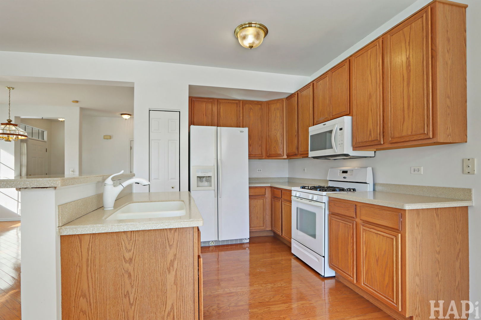 373 Keswick Court, Unit 373 Round Lake, IL 60073 - Photo 6 of 30 a kitchen with stainless steel appliances granite countertop a refrigerator a stove top oven a sink and dishwasher