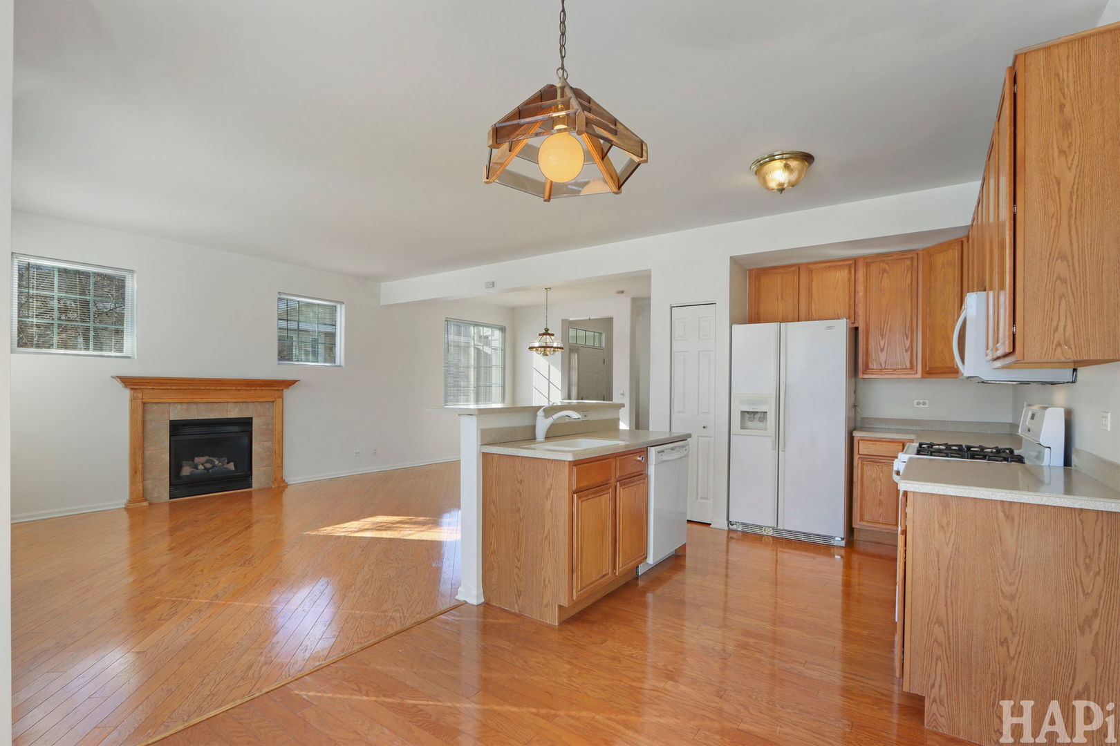 373 Keswick Court, Unit 373 Round Lake, IL 60073 - Photo 9 of 30 a kitchen with stainless steel appliances granite countertop a stove and a refrigerator