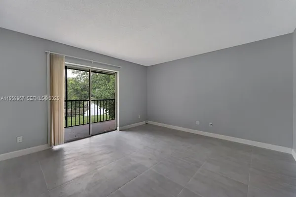 a view of an empty room with a balcony