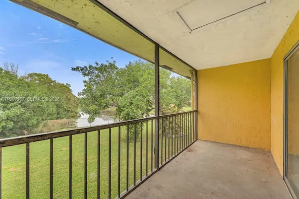 a view of balcony with yard