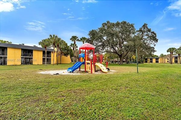 a view of a playground with a swimming pool