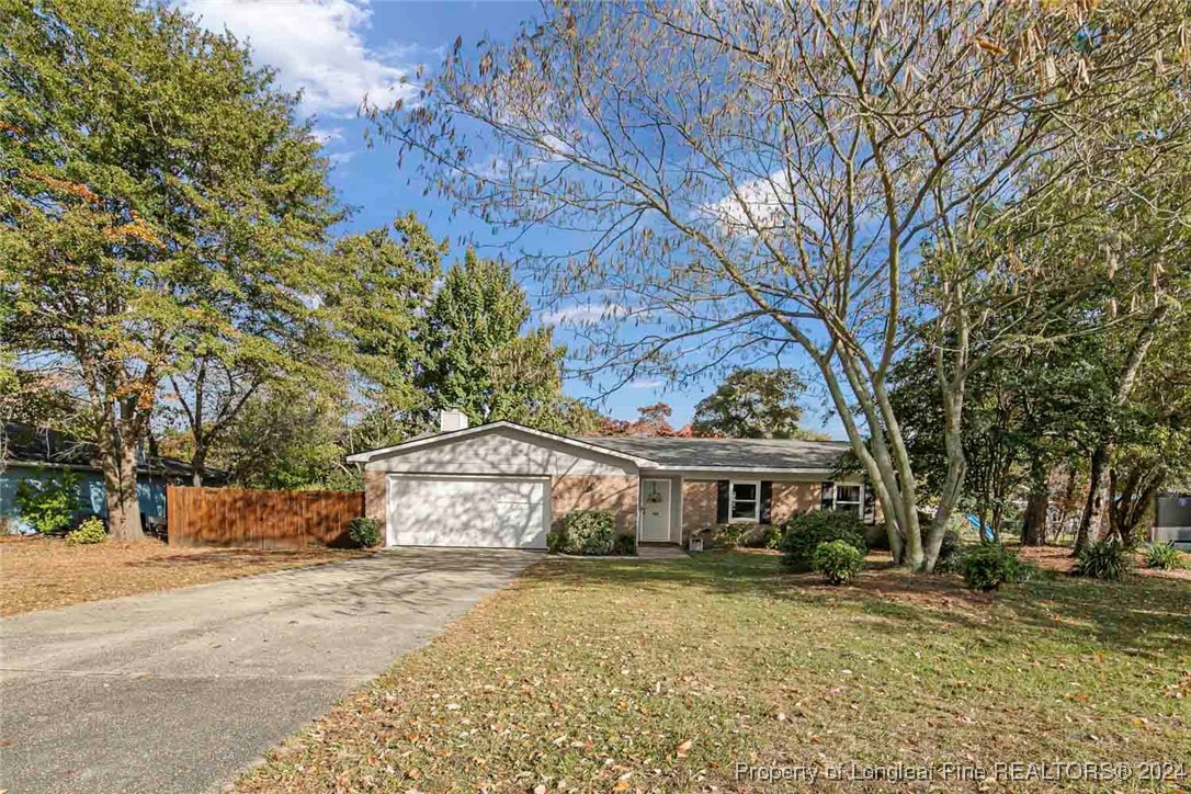 3009 Rouse Road Fayetteville, NC 28306 - Photo 1 of 37 a front view of a house with a garden