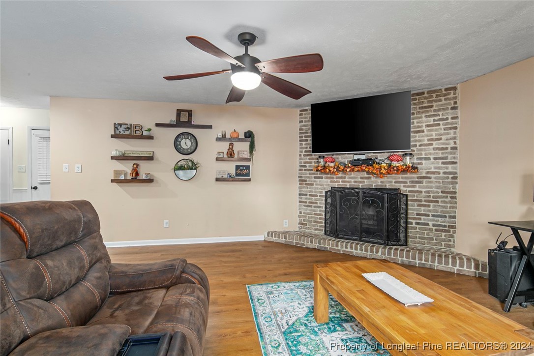 3009 Rouse Road Fayetteville, NC 28306 - Photo 18 of 37 a living room with furniture a flat screen tv and a fireplace