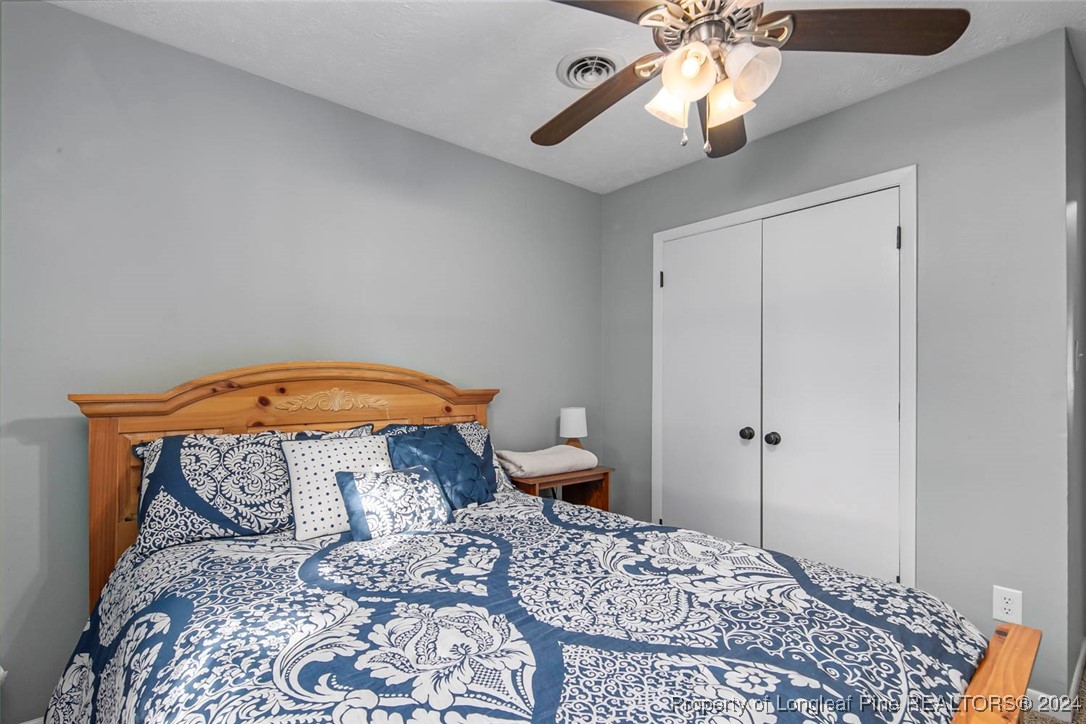 3009 Rouse Road Fayetteville, NC 28306 - Photo 21 of 37 a bedroom with a bed and a chandelier